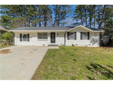 Charming single-story home featuring a well-maintained lawn and freshly painted white exterior at 80 Crystal River Dr, Riverdale, GA 30274