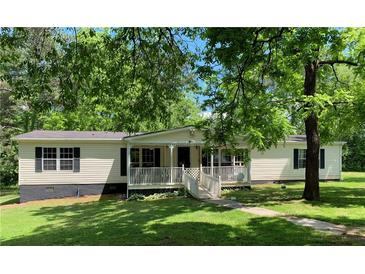 Charming single story home with front porch and mature shade trees at 6675 Millwood Rd, Cumming, GA 30041