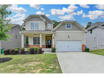 Charming two-story home features a covered front porch and attached two car garage at 7760 Hansel Ln, Lithonia, GA 30058