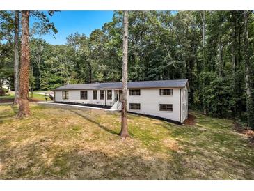 Beautifully renovated home with crisp white exterior and thoughtfully manicured landscaping at 3420 Burnt Hickory Nw Rd, Marietta, GA 30064