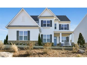 Charming two-story home with a stone foundation, black shutters, white siding, and a covered front porch at 2905 Medford Drive, Cumming, GA 30041