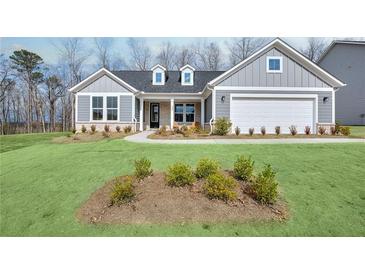 Charming single-story home with a manicured lawn, attached garage, and welcoming front porch at 2905 Medford Drive, Cumming, GA 30041