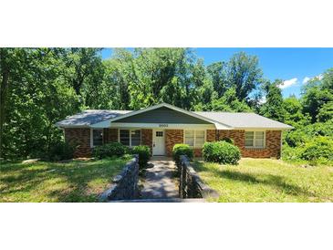 Charming brick home with a well-maintained front yard and mature trees providing ample shade at 2663 Washington Nw St, Atlanta, GA 30318