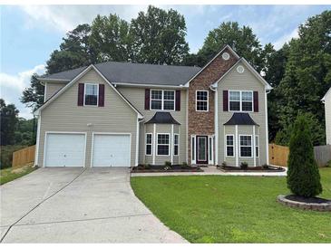 Charming two-story home featuring a two-car garage and well-manicured front lawn at 4805 Madison Point Cir, Austell, GA 30106
