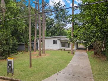 Charming one-story home with a long driveway and a well-maintained lawn at 2575 Flagstone Se Dr, Atlanta, GA 30316