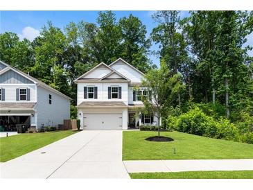 Charming two-story home with a manicured lawn, driveway, and attached garage at 160 Winner St, Acworth, GA 30102