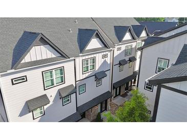 Charming townhomes with modern architectural details and dark rooflines create a cohesive and appealing street view at 2587 Ocean Walk Nw Dr, Atlanta, GA 30318