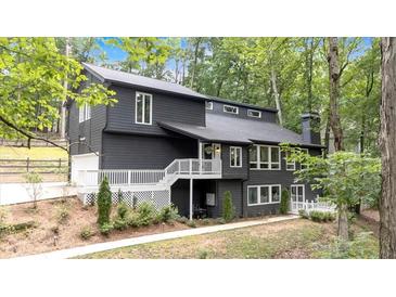 Charming two-story home featuring a spacious deck, modern siding, and lush greenery at 510 Watergate Ct, Roswell, GA 30076