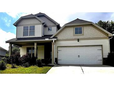 Charming two-story home with an attached two-car garage and well-maintained front yard at 2363 Bear Mountain St, Lithonia, GA 30058