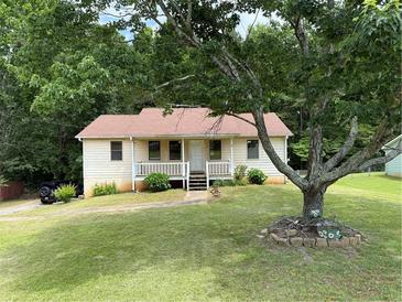 Charming single-story home with a well-manicured lawn and mature trees at 285 Woodland St, Dallas, GA 30157