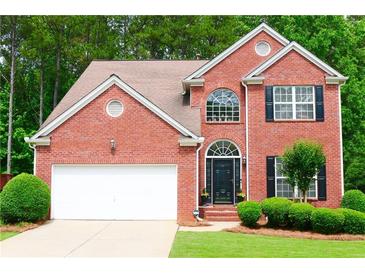 Charming brick two-story home with landscaped front yard and attached two-car garage at 318 Ivy Manor Nw Dr, Marietta, GA 30064