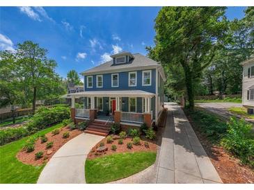Charming two-story blue home with a welcoming front porch and a beautifully landscaped front yard at 417 S Candler St, Decatur, GA 30030