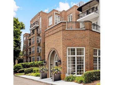 Brick building featuring elegant windows, wrought iron balconies, and manicured landscaping around the property at 175 15Th Ne St # 410, Atlanta, GA 30309