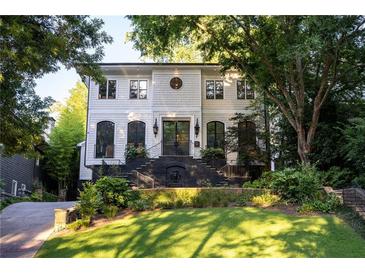 Stunning two-story home with manicured lawn and elegant black brick stairway at 21 Barksdale Ne Dr, Atlanta, GA 30309