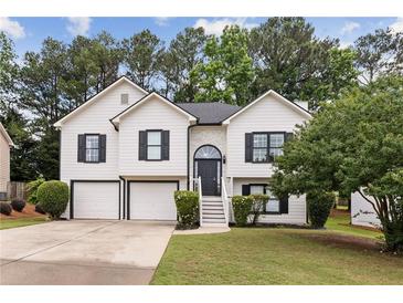 Charming two-story home features a manicured lawn and attached two-car garage, enhancing curb appeal at 4733 Julian Way, Acworth, GA 30101