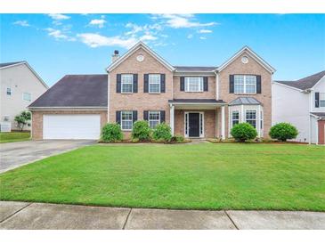 Charming two-story brick home with a well-manicured lawn and inviting curb appeal at 841 Holly Meadow Dr, Buford, GA 30518