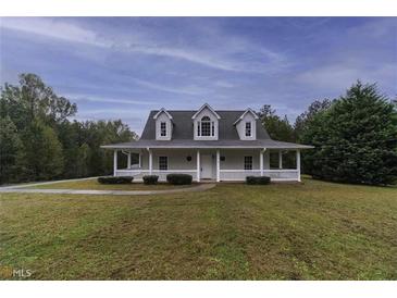 Charming home featuring a large front porch, dormer windows, and a well-maintained lawn at 385 Eagles Nest Cir, Carrollton, GA 30116