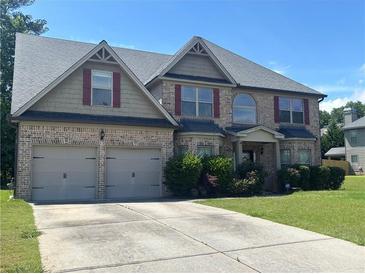 Beautiful brick two-story home featuring a two-car garage, manicured lawn, and traditional architectural details at 4482 Ridge Mill Ne Ter, Douglasville, GA 30135