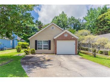 Charming single Gathering home featuring a single car garage, brick accent, and beautifully manicured lawn at 1321 Waterton Trl, Douglasville, GA 30134