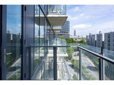 Condo balcony featuring glass railings with a view of the city skyline at 788 W Marietta Nw St # 311, Atlanta, GA 30318