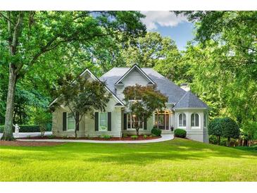 Charming traditional home with lush landscaping and a well-manicured lawn at 10635 N Edgewater, Johns Creek, GA 30097