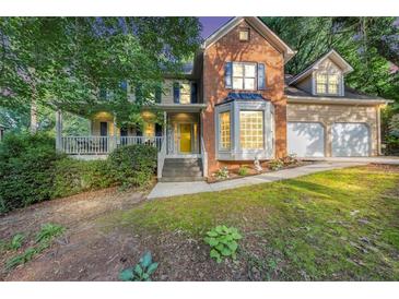 Charming two-story home boasting a brick facade, covered porch, and a two-car garage at 4817 Overland Dr, Powder Springs, GA 30127