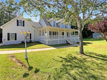 Charming two-story home featuring a large porch, well-manicured lawn, and beautiful curb appeal at 132 Lynnview Ct, Mcdonough, GA 30252