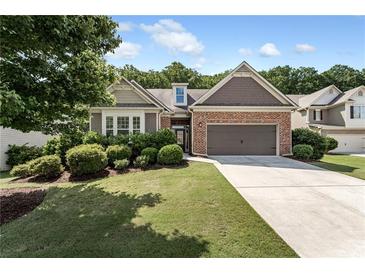 Charming home with a brick facade, manicured landscaping, and a two-car garage at 1955 Overlook Run Pl, Cumming, GA 30040