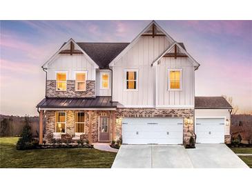 Charming two-story home showcasing a blend of board and batten siding and brick, creating a modern farmhouse aesthetic at 4720 Montane St, Cumming, GA 30028