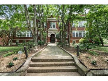 Charming brick building with a landscaped entrance and mature trees, offering a warm and inviting welcome at 1031 State Nw St # 106, Atlanta, GA 30318
