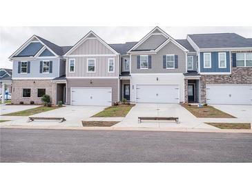 Charming townhomes with attached garages, colorful siding, and inviting curb appeal on a quiet street at 6007 Pine Bluff Pl, Conyers, GA 30013