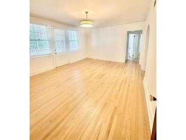 Bright living room featuring beautiful hardwood floors and large windows for natural light at 2230 Peachtree Road Nw Rd # A4, Atlanta, GA 30309