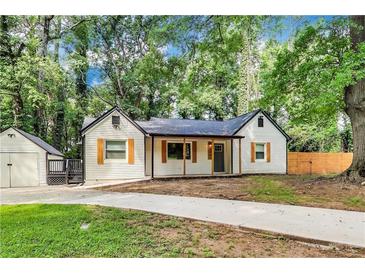 Charming home with wooden shutters and a spacious driveway surrounded by mature trees at 500 Pomoma Circle Sw, Atlanta, GA 30315