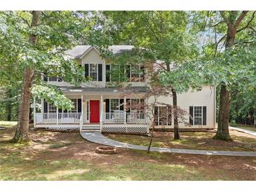 Charming two-story home featuring a welcoming front porch with a bright red door at 701 Robert Ln, Canton, GA 30114