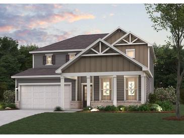 Charming two-story home with a welcoming front porch, well-manicured lawn, and an attached two-car garage at 777 Ruddy Drive (Lot20), Grayson, GA 30017