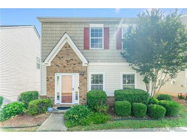Charming two-story home with brick and shake siding, plus a well-manicured front yard with lush landscaping at 3134 Imperial Sw Cir, Atlanta, GA 30311