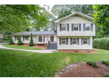 Charming two-story home with a well-maintained lawn and inviting curb appeal, surrounded by mature trees at 2786 Georgian Ter, Marietta, GA 30068
