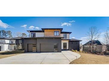 Stunning modern home with a three-car garage and sleek architectural design at 2551 Kilgore Rd, Buford, GA 30519