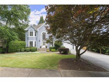 Charming two-story home with a well-manicured lawn and beautiful landscaping at 3260 Kingshouse Commons, Johns Creek, GA 30022