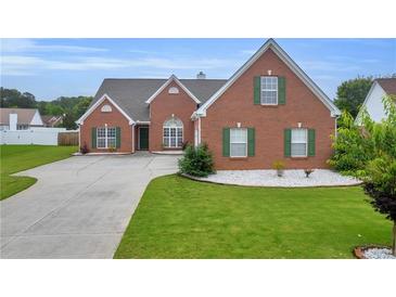 Charming brick home with manicured lawn and green shutters at 502 Stoneland Pl, Lawrenceville, GA 30046
