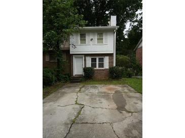 Charming two-story home with a brick front and a cracked driveway at 936 Glynn Oaks Dr, Clarkston, GA 30021