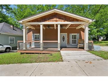 Charming home with a welcoming front porch, complete with porch swing and stylish railings at 999 Smith Sw St, Atlanta, GA 30310