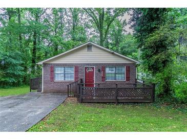 Charming single-story brick home featuring a cozy front porch and well-maintained landscaping at 2045 Scarbrough Dr, Stone Mountain, GA 30088