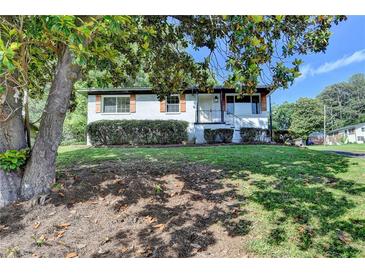 Charming single-story home with manicured front yard and mature tree providing shade at 3991 Adamsville Sw Dr, Atlanta, GA 30331
