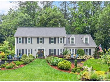 Beautiful two-story home featuring lush landscaping and a manicured lawn at 1540 Kinglet Ln, Marietta, GA 30062