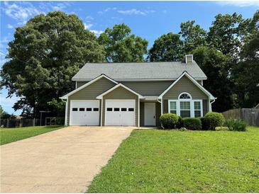 Charming home features a two-car garage, well-manicured lawn, and mature shade trees at 3722 Cherokee Overlook Dr, Canton, GA 30115