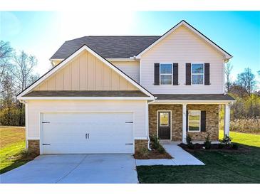 Charming two-story home with a two-car garage, stone accents, and a well-manicured lawn at 471 Charleston Pl, Villa Rica, GA 30180