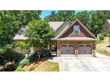 Charming home with stone accents, well-manicured landscaping, and a two-car garage at 34 Laurel Ne Way, White, GA 30184