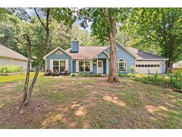 Charming single-story home with a lush front yard and attached two-car garage at 2395 Holly Branch Dr, Cumming, GA 30040