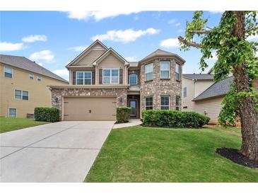Charming two-story home featuring a brick and siding facade, well-manicured lawn, and an attached two-car garage at 29 Lankford Rd, Tucker, GA 30084